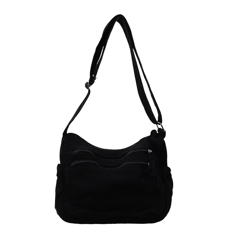 👜✨ Pojemna torba na ramię z płótna o efekcie postarzenia: wyróżnia się wielokomorową konstrukcją z zapięciami na suwak oraz szerokim, regulowanym paskiem.